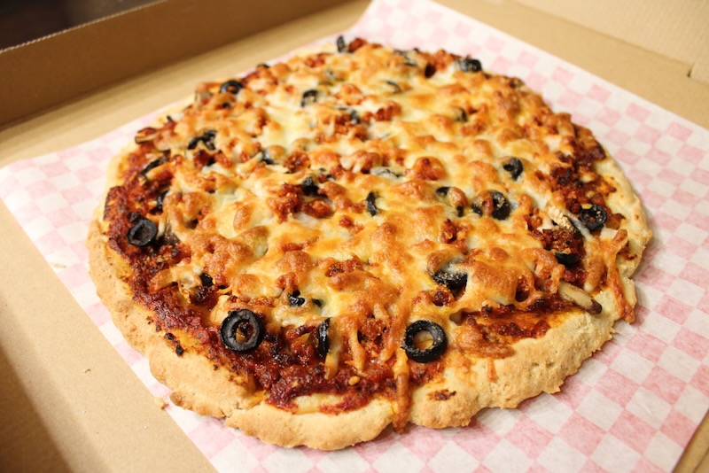 Freshly baked pepperoni pizza from a local pizzeria, ready for delivery